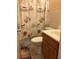 Bathroom with seashell shower curtain and wooden vanity at 4300 58Th N St # 2000, Kenneth City, FL 33709