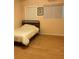 Bedroom with double bed and wood-look flooring at 4300 58Th N St # 2000, Kenneth City, FL 33709