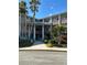 Brick building exterior with palm trees and a walkway at 4300 58Th N St # 2000, Kenneth City, FL 33709
