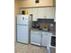 Bright kitchen features white cabinets, dishwasher, and refrigerator at 4300 58Th N St # 2000, Kenneth City, FL 33709