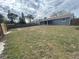 Spacious backyard with a large grassy area and privacy fence at 7318 Dianne Dr, New Port Richey, FL 34652