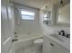 Updated bathroom with a bathtub, vanity, and tiled flooring at 7318 Dianne Dr, New Port Richey, FL 34652