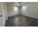 Large bedroom with two windows and vinyl plank flooring at 7318 Dianne Dr, New Port Richey, FL 34652