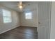 Well-lit bedroom with two windows and vinyl plank floors at 7318 Dianne Dr, New Port Richey, FL 34652