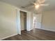 Bright bedroom with ceiling fan, closet, and vinyl plank flooring at 7318 Dianne Dr, New Port Richey, FL 34652