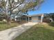 Newly renovated home with gray exterior, stone accents, and a spacious driveway at 7318 Dianne Dr, New Port Richey, FL 34652