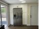 Modern kitchen with white cabinets, stainless steel appliances, and wood-look floors at 7318 Dianne Dr, New Port Richey, FL 34652