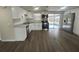 Modern kitchen with white cabinets, stainless steel appliances, and wood-look floors at 7318 Dianne Dr, New Port Richey, FL 34652