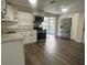 Modern kitchen with white cabinets, stainless steel appliances, and wood-look floors at 7318 Dianne Dr, New Port Richey, FL 34652