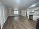 Spacious living room with wood-look floors and access to kitchen at 7318 Dianne Dr, New Port Richey, FL 34652
