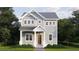 Two-story craftsman style home with gray siding, white trim, and landscaping at 744 47Th N Ave, St Petersburg, FL 33703