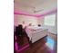 Bedroom with a queen bed, pink lighting, and hardwood floors at 7634 Desoto Ct, Tampa, FL 33615