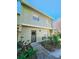 Two-story townhome with a landscaped front yard and a walkway at 7634 Desoto Ct, Tampa, FL 33615