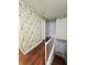 Upper hallway with floral wallpaper and wood flooring at 7634 Desoto Ct, Tampa, FL 33615
