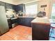 Modern kitchen with dark cabinets, stainless steel appliances, and butcher block island at 7634 Desoto Ct, Tampa, FL 33615