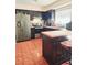 Modern kitchen with dark cabinets, stainless steel appliances, and butcher block island at 7634 Desoto Ct, Tampa, FL 33615