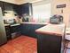 Modern kitchen with dark cabinets, stainless steel appliances, and butcher block island at 7634 Desoto Ct, Tampa, FL 33615