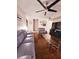 Living room with hardwood floors, gray seating, and a large TV at 7634 Desoto Ct, Tampa, FL 33615