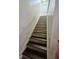 Indoor staircase with tiled steps and white walls at 7634 Desoto Ct, Tampa, FL 33615