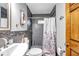 Updated bathroom with gray tile shower and white vanity at 8 Citrus Dr, Palm Harbor, FL 34684