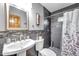 Modern bathroom with gray tile, shower, and pedestal sink at 8 Citrus Dr, Palm Harbor, FL 34684