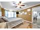 Well-lit bedroom with a queen bed and access to kitchen at 8 Citrus Dr, Palm Harbor, FL 34684