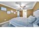 Bright bedroom with a ceiling fan and comfortable bedding at 8 Citrus Dr, Palm Harbor, FL 34684