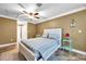 Bedroom with ceiling fan and view of bathroom at 8 Citrus Dr, Palm Harbor, FL 34684