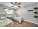 Guest bedroom with twin beds, ceiling fan, and wood flooring at 8 Citrus Dr, Palm Harbor, FL 34684