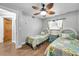 Guest bedroom with twin beds, ceiling fan, and wood flooring at 8 Citrus Dr, Palm Harbor, FL 34684