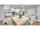 View of the dining area with a wooden table and chairs, kitchen in the background at 8 Citrus Dr, Palm Harbor, FL 34684