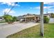 One story home with stone exterior, driveway, and mature landscaping at 8 Citrus Dr, Palm Harbor, FL 34684