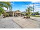 Single-story home with stone exterior and a circular driveway at 8 Citrus Dr, Palm Harbor, FL 34684