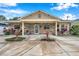 Cute one-story home with stone exterior, covered porch, and landscaped yard at 8 Citrus Dr, Palm Harbor, FL 34684