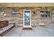 Inviting front porch with a wooden swing and a welcome mat at 8 Citrus Dr, Palm Harbor, FL 34684