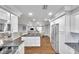 Open concept kitchen with island, stainless steel appliances, and hardwood floors at 8 Citrus Dr, Palm Harbor, FL 34684