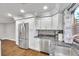 Modern kitchen with white cabinets, stainless steel appliances, and granite countertops at 8 Citrus Dr, Palm Harbor, FL 34684