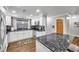 White shaker cabinets, granite counters, and stainless steel appliances in this kitchen at 8 Citrus Dr, Palm Harbor, FL 34684
