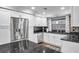 Updated kitchen with white cabinets and granite countertops at 8 Citrus Dr, Palm Harbor, FL 34684