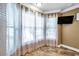 Living room with large windows and mounted TV at 8 Citrus Dr, Palm Harbor, FL 34684