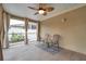 Cozy screened porch with seating area and ceiling fan at 8 Citrus Dr, Palm Harbor, FL 34684