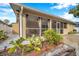 Lovely screened porch with wooden planter and cactus plants at 8 Citrus Dr, Palm Harbor, FL 34684
