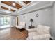 Cozy sitting area with coffered ceiling, comfy chairs, and wood floors at 8 Citrus Dr, Palm Harbor, FL 34684