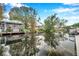 Calm waterfront view with house reflection and boats at 8 Citrus Dr, Palm Harbor, FL 34684