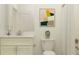 Clean bathroom with a white vanity and a framed print at 9650 Minnow Ray Dr, Land O Lakes, FL 34638