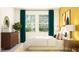 Bedroom with teal curtains and a wooden dresser at 9650 Minnow Ray Dr, Land O Lakes, FL 34638