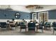 Charming community room with blue accents and multiple tables at 9650 Minnow Ray Dr, Land O Lakes, FL 34638