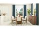 Dining room with a wooden table and teal curtains at 9650 Minnow Ray Dr, Land O Lakes, FL 34638