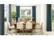 Light and airy dining room with a wooden table and chairs at 9650 Minnow Ray Dr, Land O Lakes, FL 34638