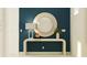 Entryway with a large round mirror and a console table at 9650 Minnow Ray Dr, Land O Lakes, FL 34638